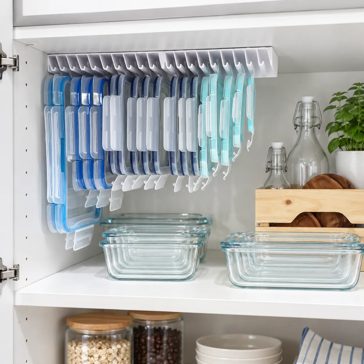 Food container lids organized underneath kitchen cabinet shelf