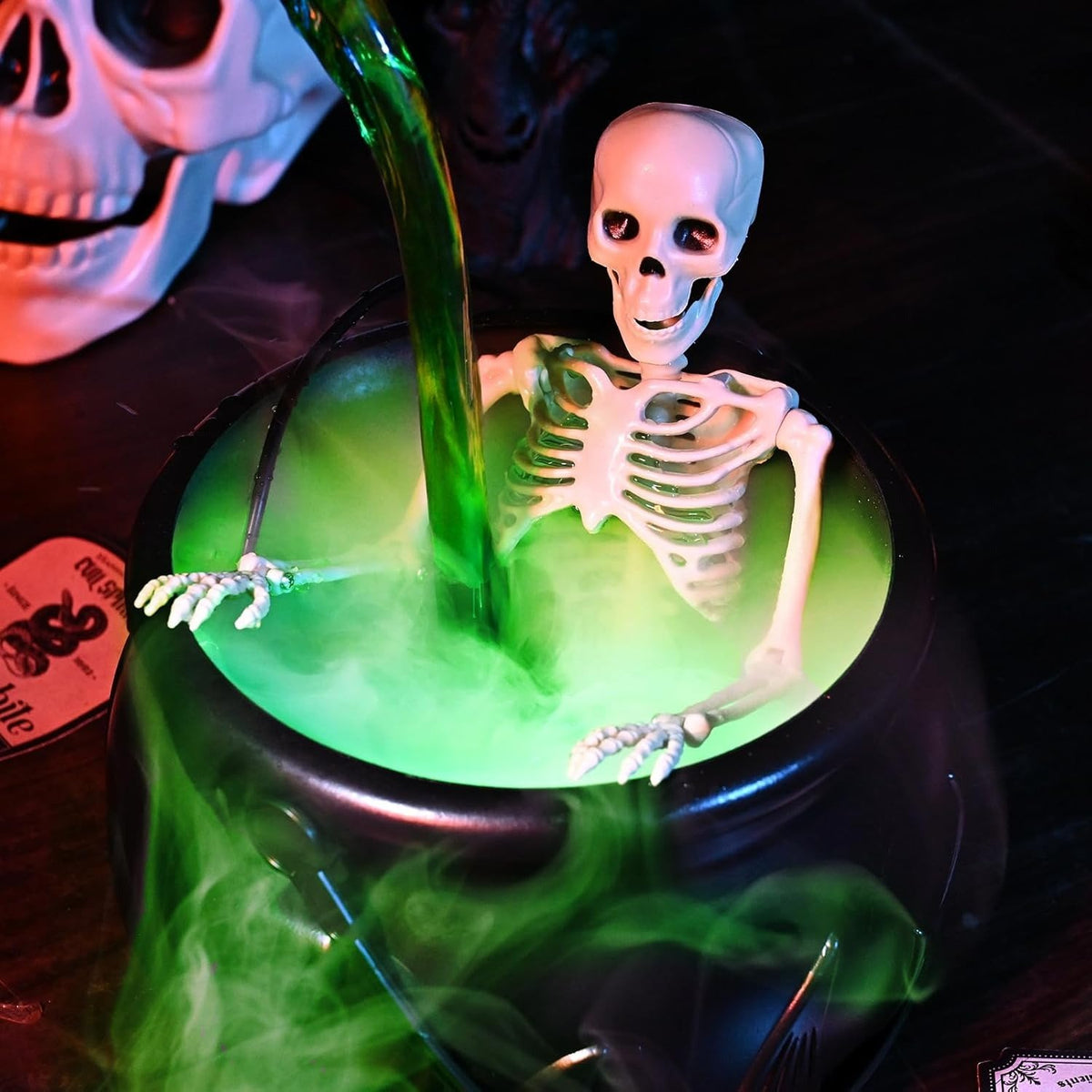 Close up skeleton emerging from glowing green fog Halloween cauldron