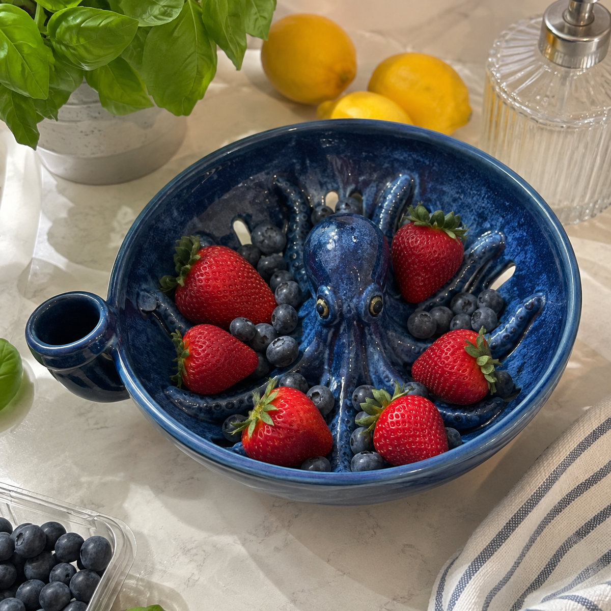 Octopus colander filled with strawberries and blueberries