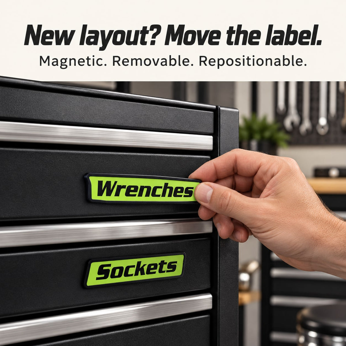 Hand repositioning a green magnetic Wrenches label on a steel toolbox
